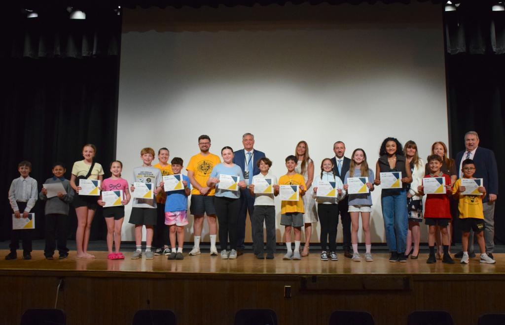 students receiving awards on stage